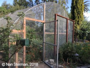 Mesh covered hoop house in Nan Sterman's garden