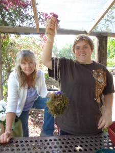 Heather Anderson and Marion Happ show their finished Kokedama