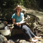 Renee Shepherd, owner of Renee's Garden seed company, cools her feet in a stream following our walk in the redwoods at Henry Cowell State Park 