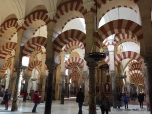 The Mezquita mosque in Cordoba is famous for its red and white striped arches and the Roman Catholic cathedral built inside of the mosque